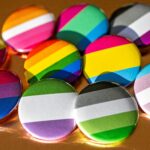 Colorful queer-themed buttons featuring various LGBTQ+ pride flags, symbolizing diversity and inclusion in queer therapy support in Halifax.
